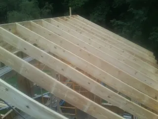 New roof rafters set over an addition before sheathing in Bulls Gap