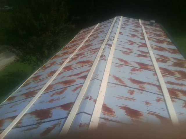 Rusted metal roof panels with new wood purlins before replacement — Storm Damage Roof Repair in Bulls Gap by Roofing Brothers
